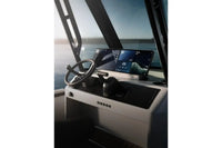 Arc Coast Electric Boat dashboard with steering wheel and digital displays on a clear day.