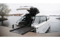Candela P-12 White amphibious Ferry with open doors on a dock by water