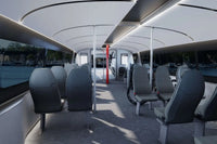 Candela P-12 Shuttle Electric Ferry Modern interior with gray seats and large windows.