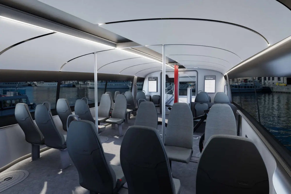 Candela P-12 Shuttle Electric Ferry Interior with gray seats and large windows showing water and boats outside.