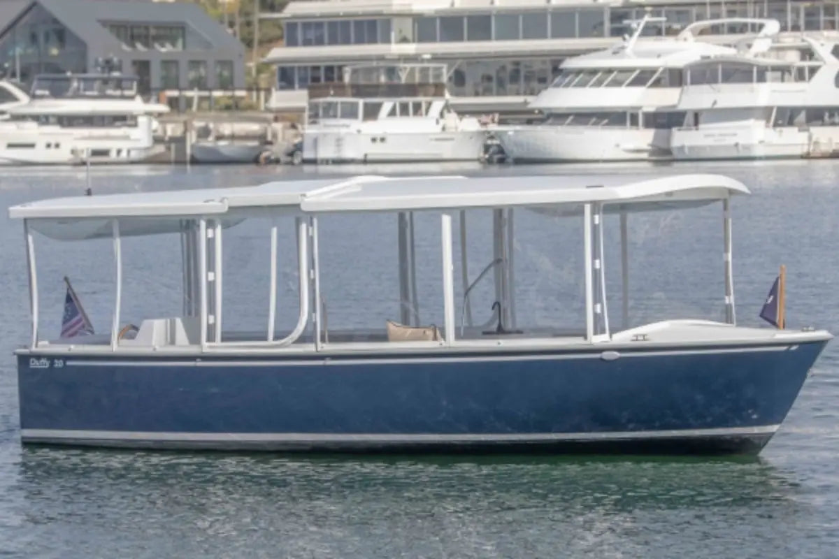 Duffy Balboa 20 Blue and white boat on water with marina in the background