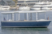 Duffy Balboa 20 Blue and white boat on water with marina in the background