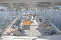 Duffy Balboa 20 Electric Boat Interior of a yacht with seating area, table, and dashboard.