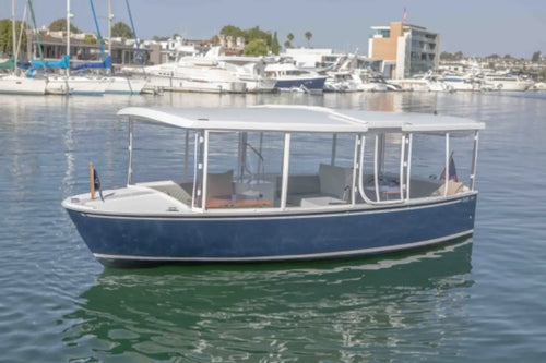 Duffy Balboa 20 Blue and white boat on a calm body of water with buildings in the background