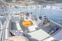 Duffy Balboa 20 Electric Boat Interior with seating area, table, and dashboard on a body of water.