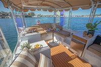Interior of a Duffy Bay Island 22 Electric Boat with seating area and view of water and city skyline