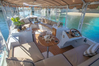 Interior of a luxurious Duffy Bay Island 22 Electric Boat with seating area and table.