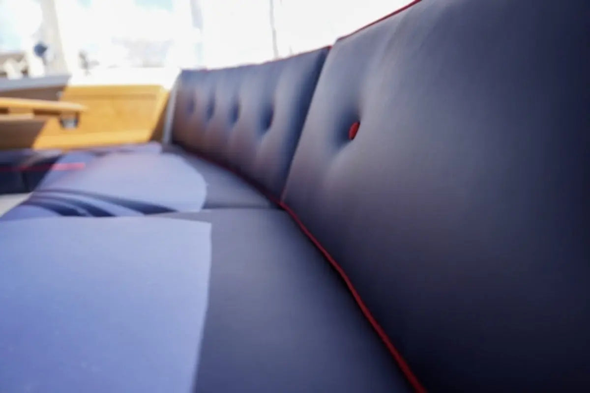 Duffy Bay Island 22 Electric Boat Section of a dark blue upholstered bench with tufted design