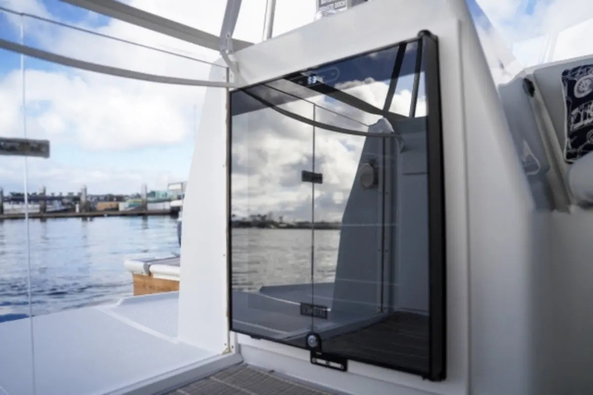 Glass door on a Duffy Cat 16 Electric Boat with water and sky in the background