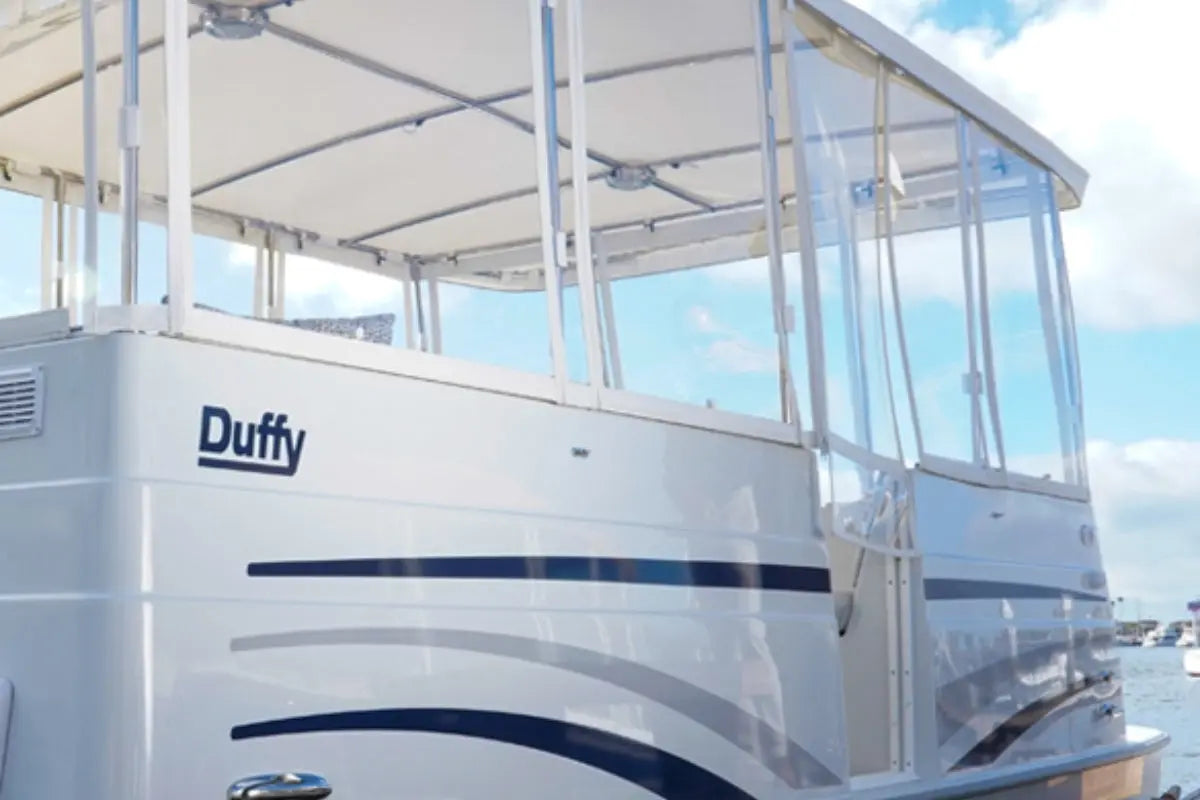 White Duffy Cat 16 Electric Boat with a clear canopy on a sunny day.