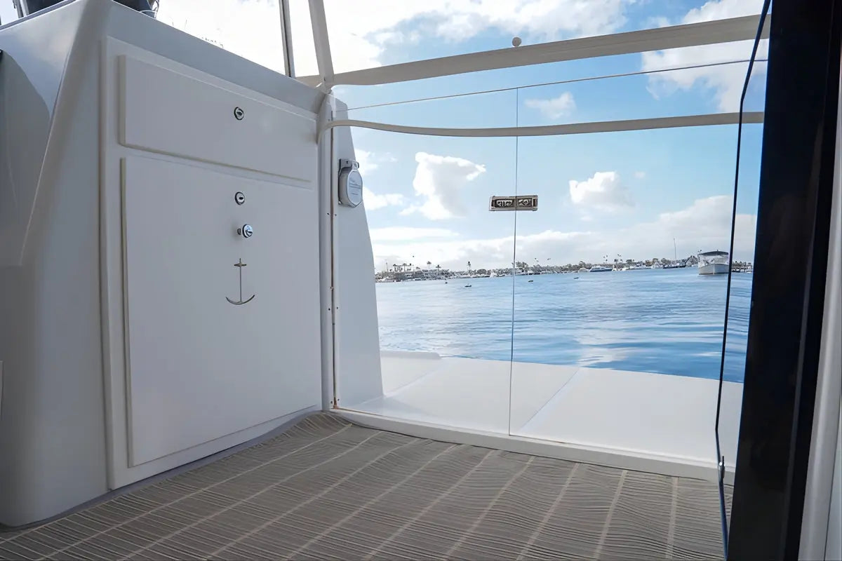 Interior of a Duffy Cat 16 Electric Boat with a view of water and sky through a large window.