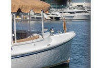 Duffy Cuddy Cabin 22 Electric Boat with a canopy on a body of water with other boats in the background