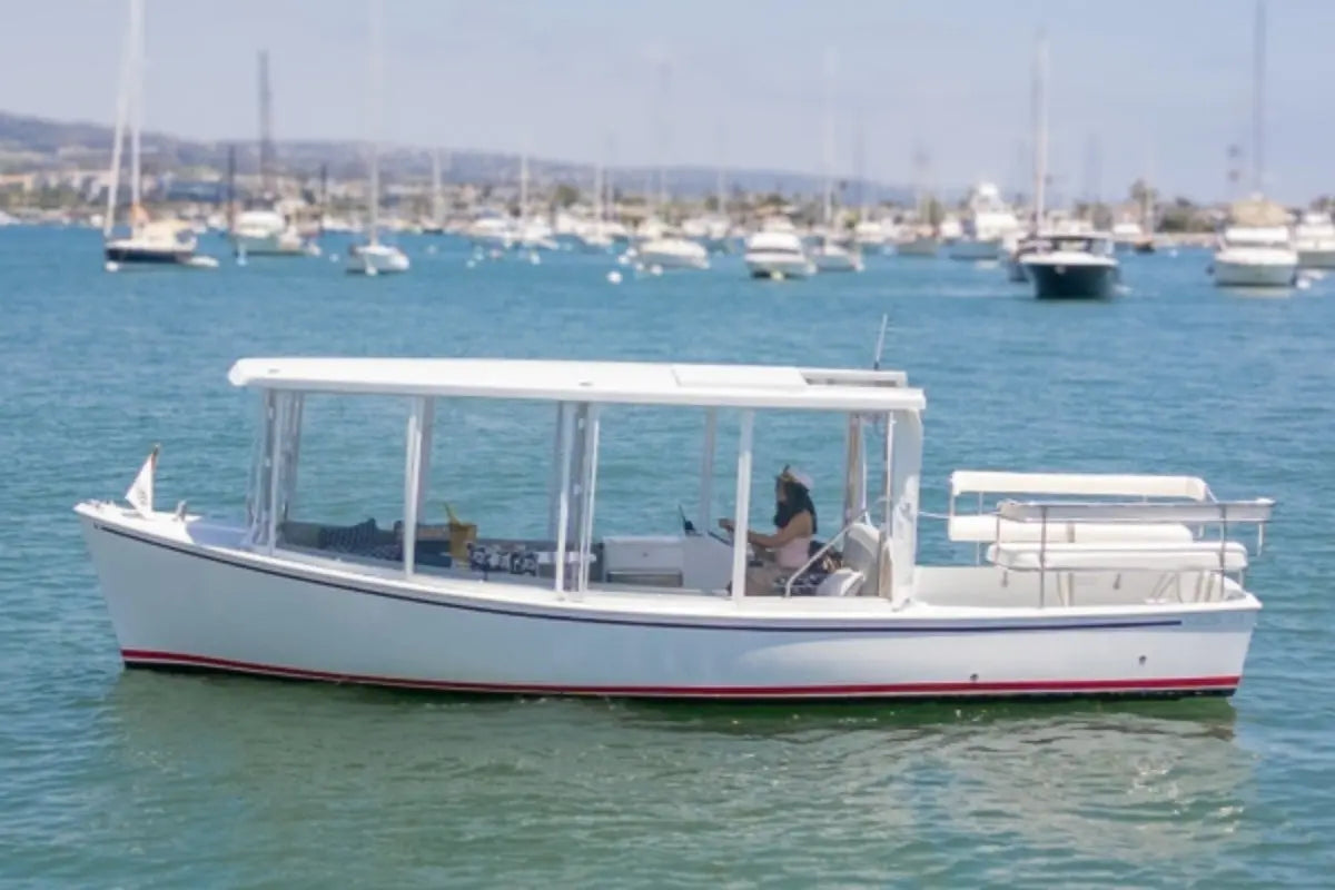 Duffy Sun Cruiser 23 Electric Boat on a body of water with other boats in the background