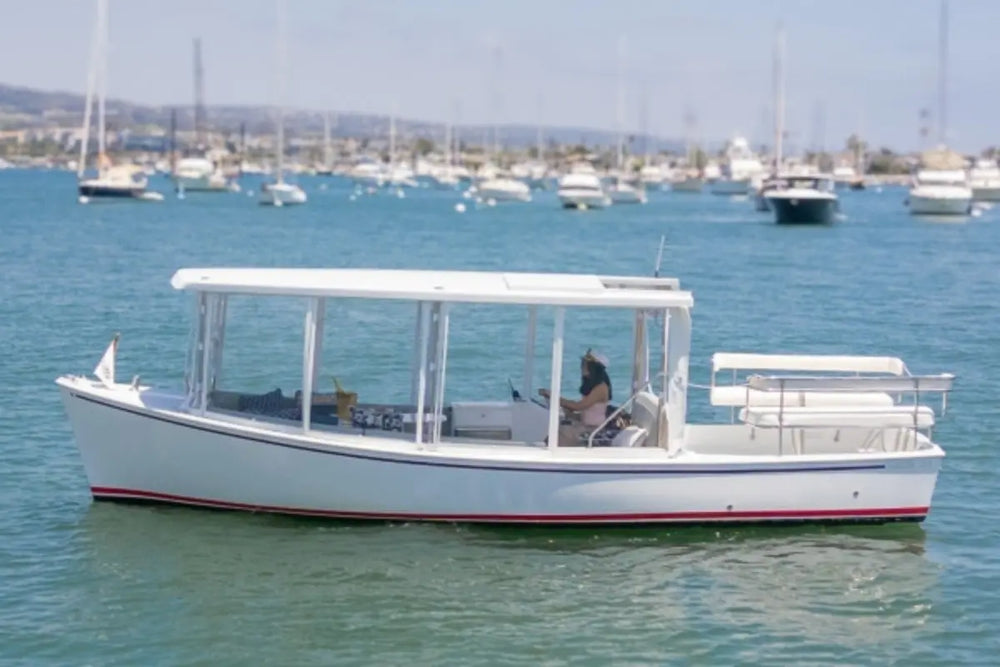 Duffy Sun Cruiser 23 Electric Boat on a body of water with other boats in the background