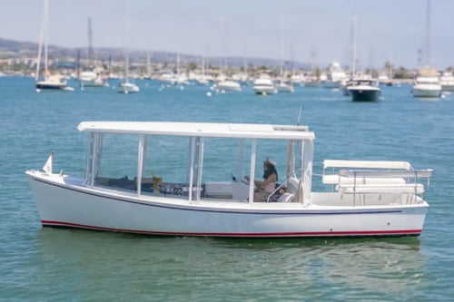 Duffy Sun Cruiser 23 Electric Boat on a body of water with other boats in the background