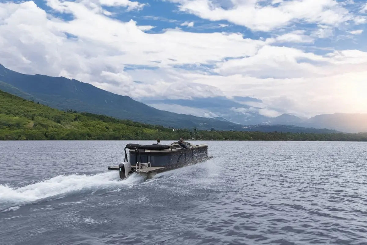 Flux Flagship Discover Electric Boat traveling on a lake with mountains in the background