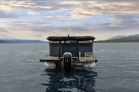 Flux Flagship Discover Electric Boat on a calm lake with mountains in the background