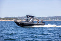 Flux Highfield Sport 660 Electric Boat with people on a body of water, likely a lake or sea, with a scenic background.