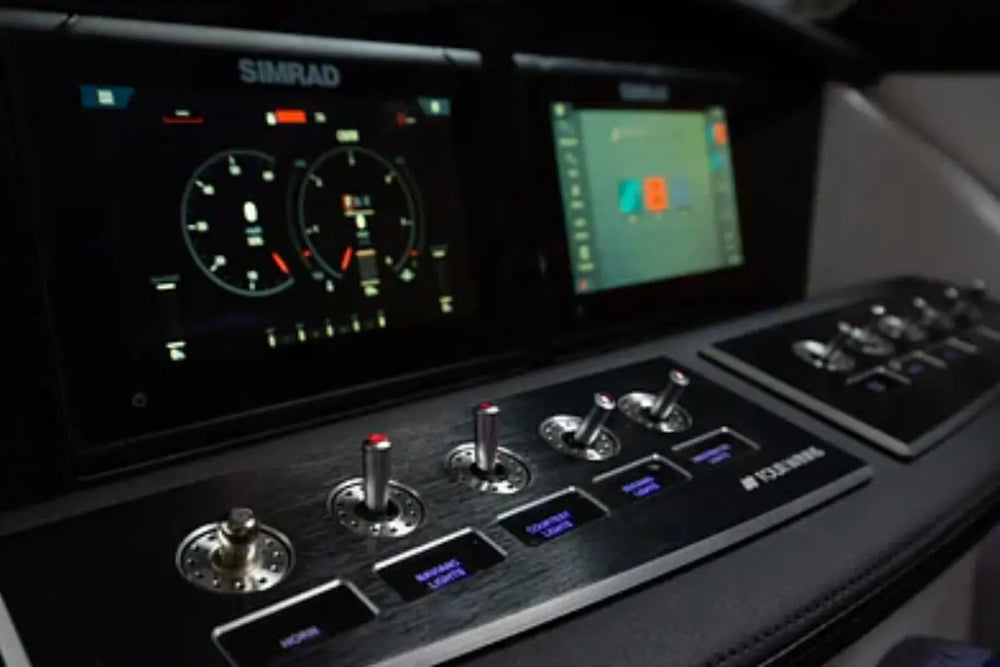 Simrad marine control panel with multiple screens and buttons