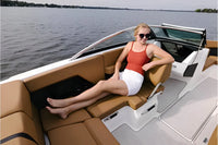 Woman sitting on Four Winns H2e Electric Boat with a scenic water background