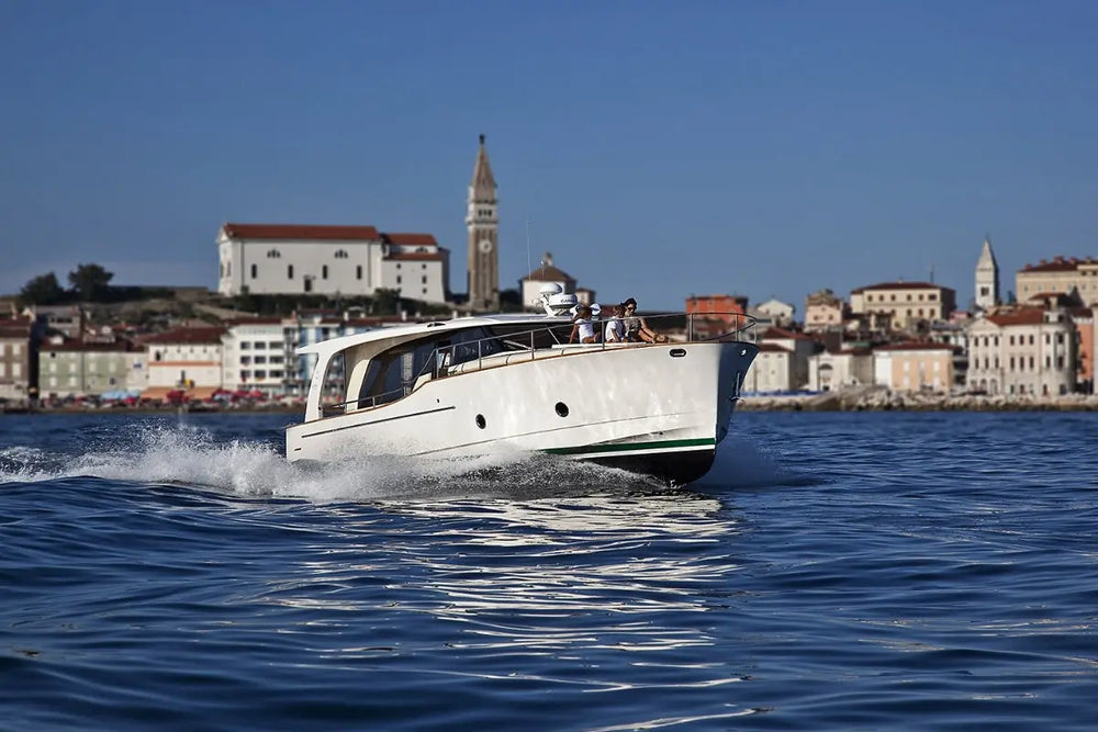 Greenline 40 Electric Yacht on water with a cityscape in the background