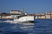 Greenline 40 Electric Yacht on water with a cityscape in the background