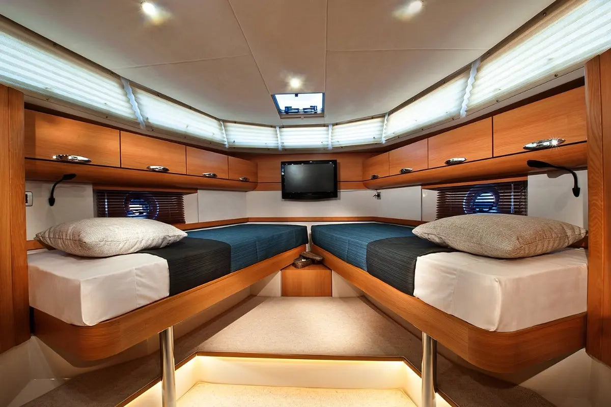 Greenline 40 Electric Yacht Nautical cabin with wooden bunk beds, television, and storage compartments.