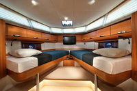 Greenline 40 Electric Yacht Nautical cabin with wooden bunk beds, television, and storage compartments.