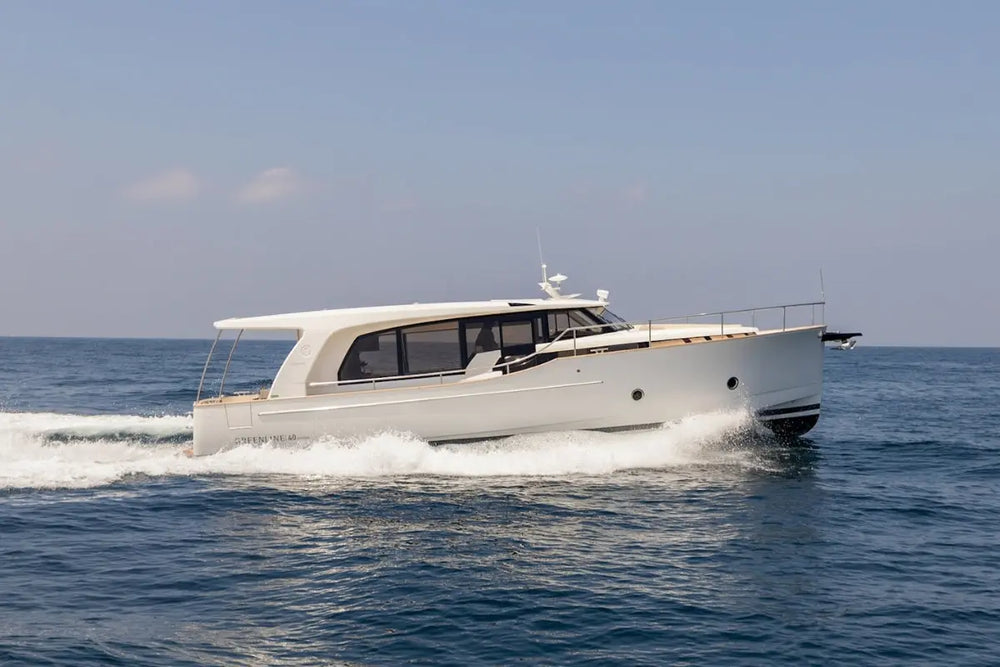 Greenline 40 Electric Yacht speeding across a blue ocean with a clear sky.
