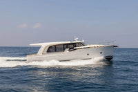 Greenline 40 Electric Yacht speeding across a blue ocean with a clear sky.