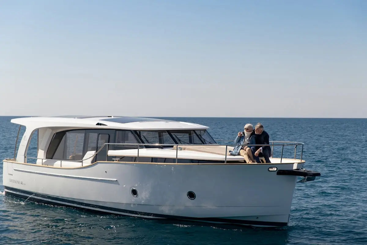 Greenline 40 Electric Yacht on the water with two people on the deck