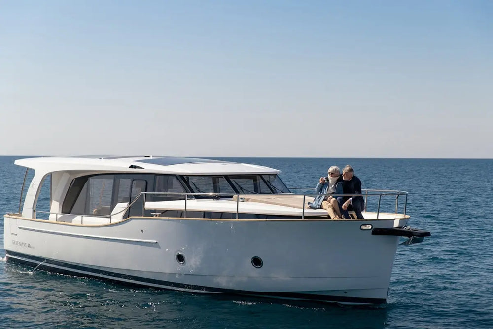Greenline 40 Electric Yacht on the water with two people on the deck