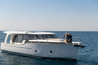 Greenline 40 Electric Yacht on the water with two people on the deck