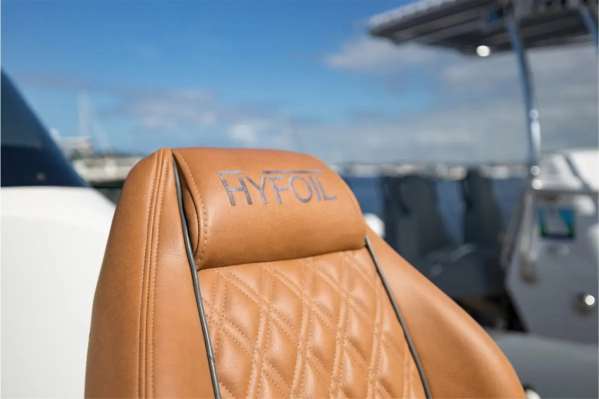 Brown leather seat with 'HYFoil' branding on a boat with a blurred background