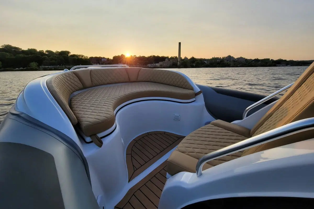 Hyfoil 28 Electric Boat interior with cushioned seats and wooden floor during sunset.