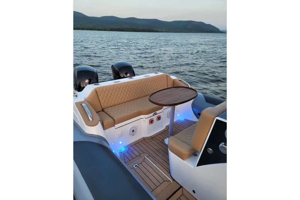 Hyfoil 28 Electric Boat interior with brown leather seats and wooden floor on a body of water.