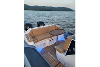 Hyfoil 28 Electric Boat interior with brown leather seats and wooden floor on a body of water.
