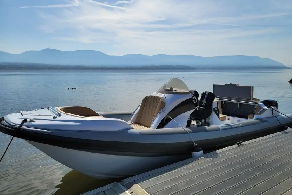 Inflatable Hyfoil 28 Electric Boat on a dock with mountains in the background
