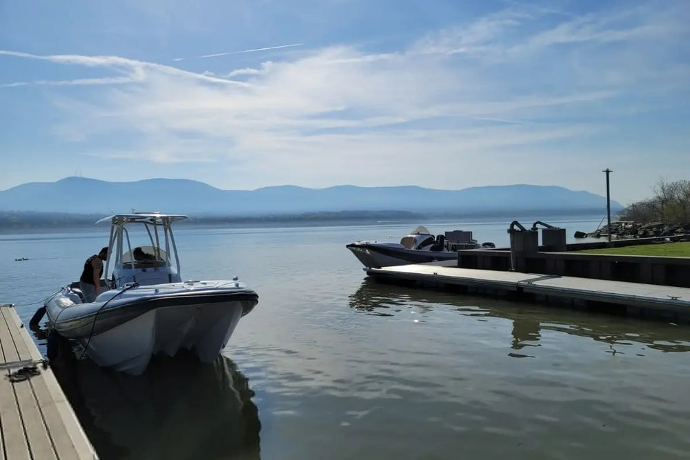 Hyfoil 28 Electric Boat docked at a pier with mountains in the background