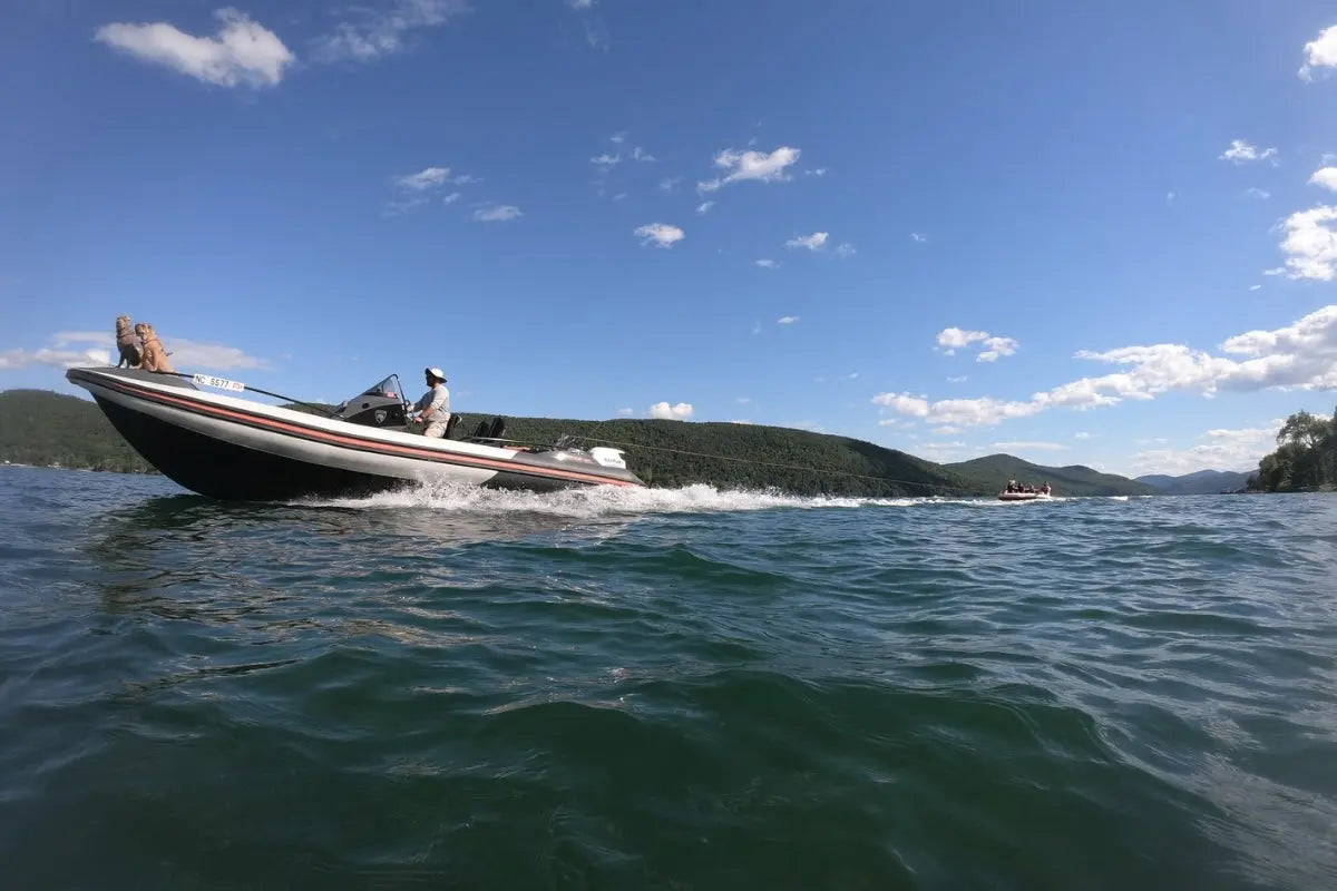 Hyfoil 28 Electric Boat on a lake with a clear blue sky and mountains in the background