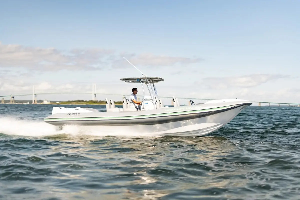Hyfoil 28 Electric Boat with a person on it moving through water with a clear sky in the background