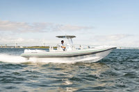 Hyfoil 28 Electric Boat with a person on it moving through water with a clear sky in the background