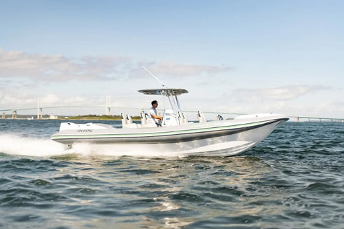Hyfoil 28 Electric Boat with a person on it moving through water with a clear sky in the background