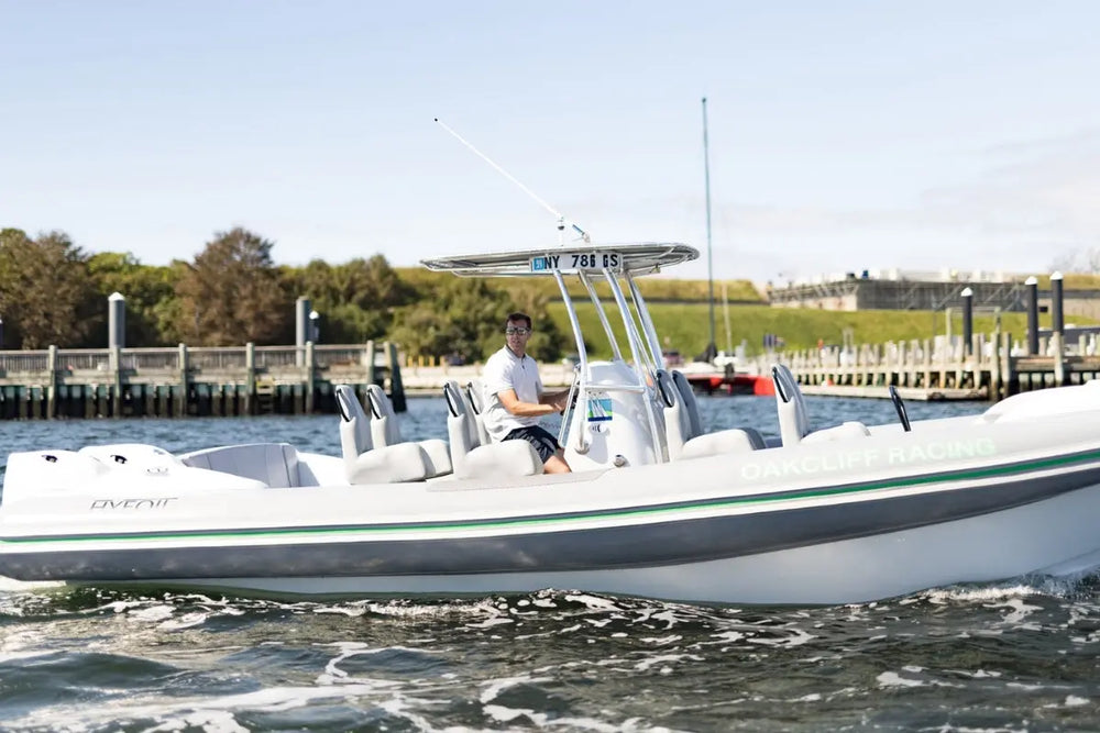 Hyfoil 28 Electric Boat with green stripe on water, person sitting inside