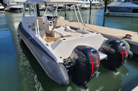 Rigid inflatable Hyfoil 32 Electric Boat with outboard motors docked at a marina