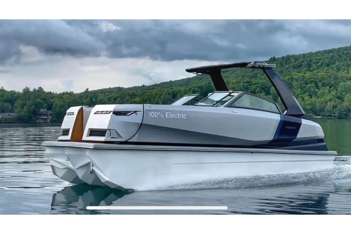 Electric Ingenity 23e Electric Boat on a lake with a scenic background