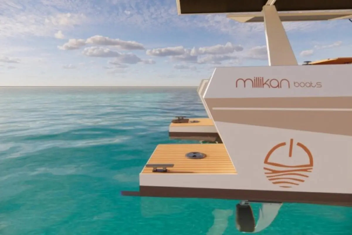 Millikan M9 Electric Boat on a dock with clear blue water and sky.