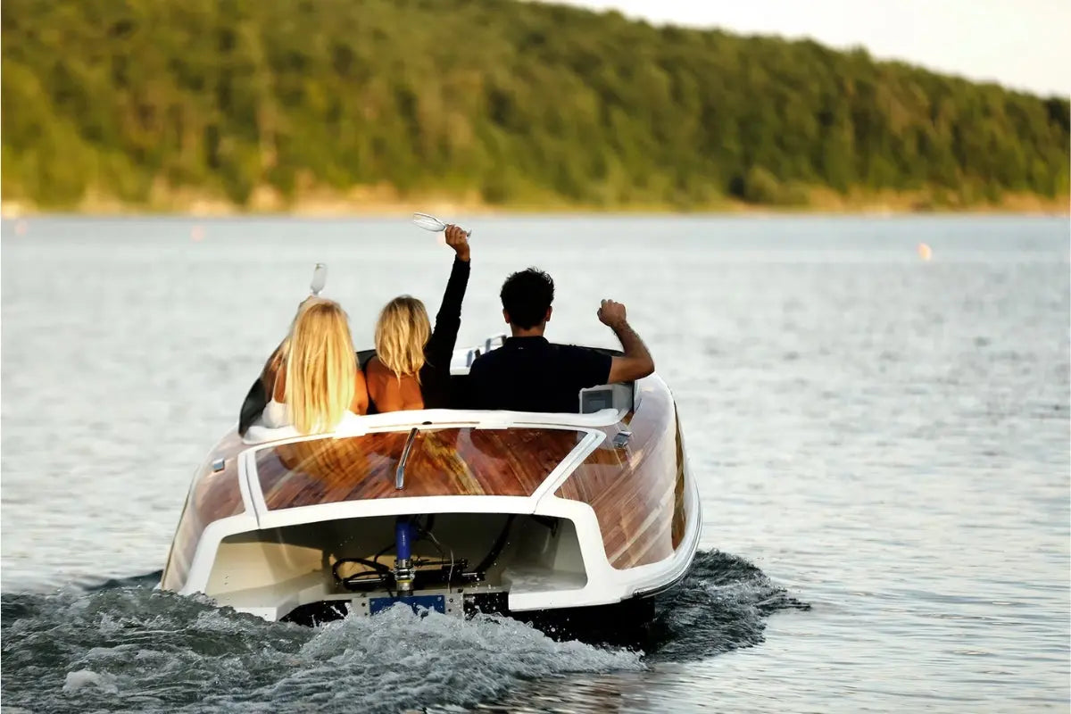 People enjoying a ride on Nova Luxe Faro Electric Boat with a scenic background