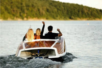 People enjoying a ride on Nova Luxe Faro Electric Boat with a scenic background