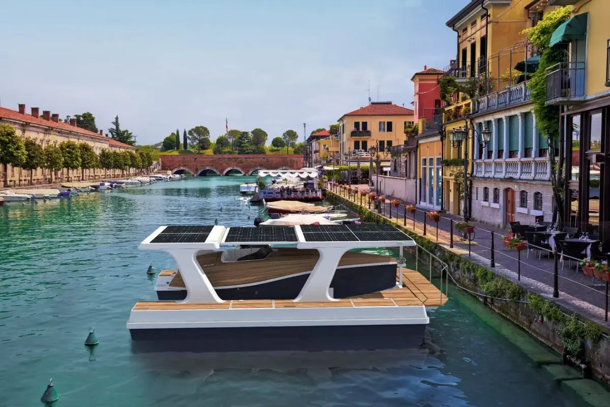 Floating Nova Luxe Faro Electric Boat with solar panels on a canal in an urban setting